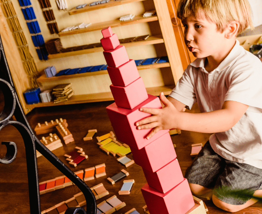 child working with Montessori Pink Tower