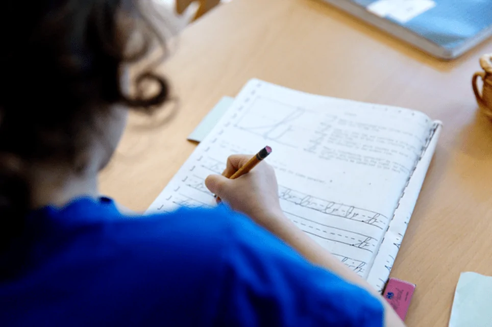 Montessori student writing