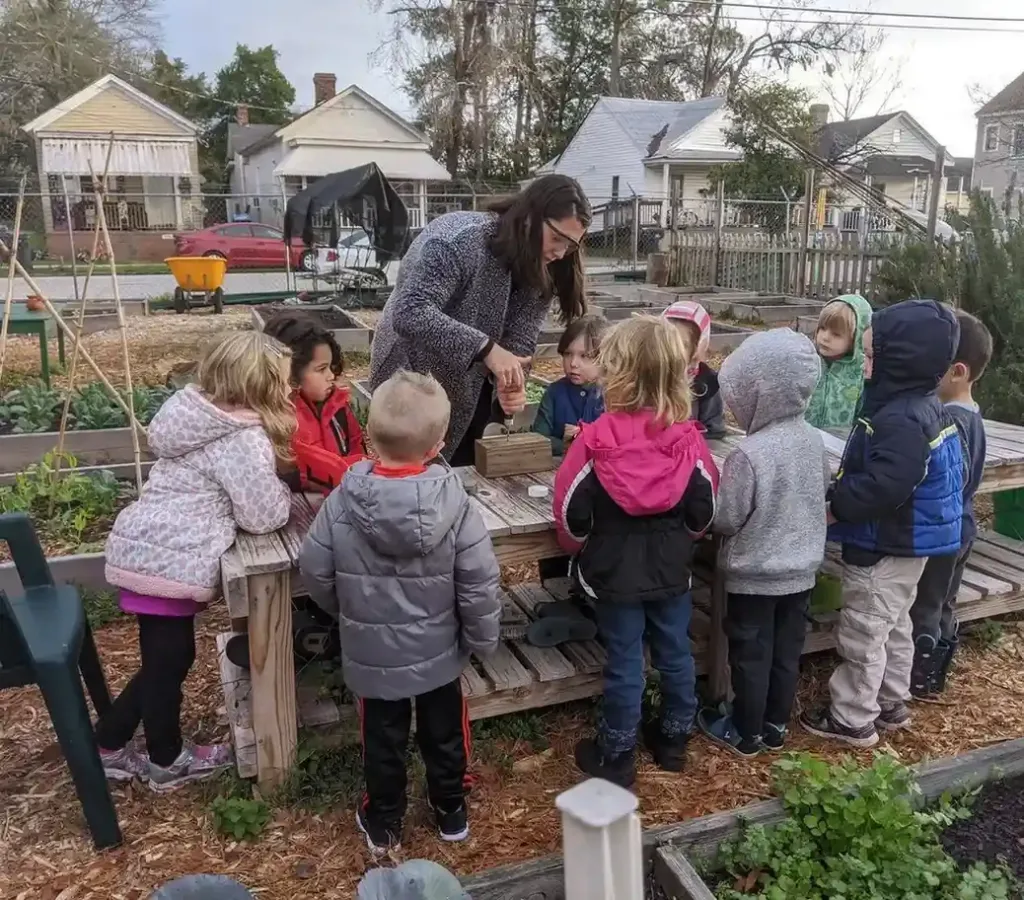 montessori teacher with students outside
